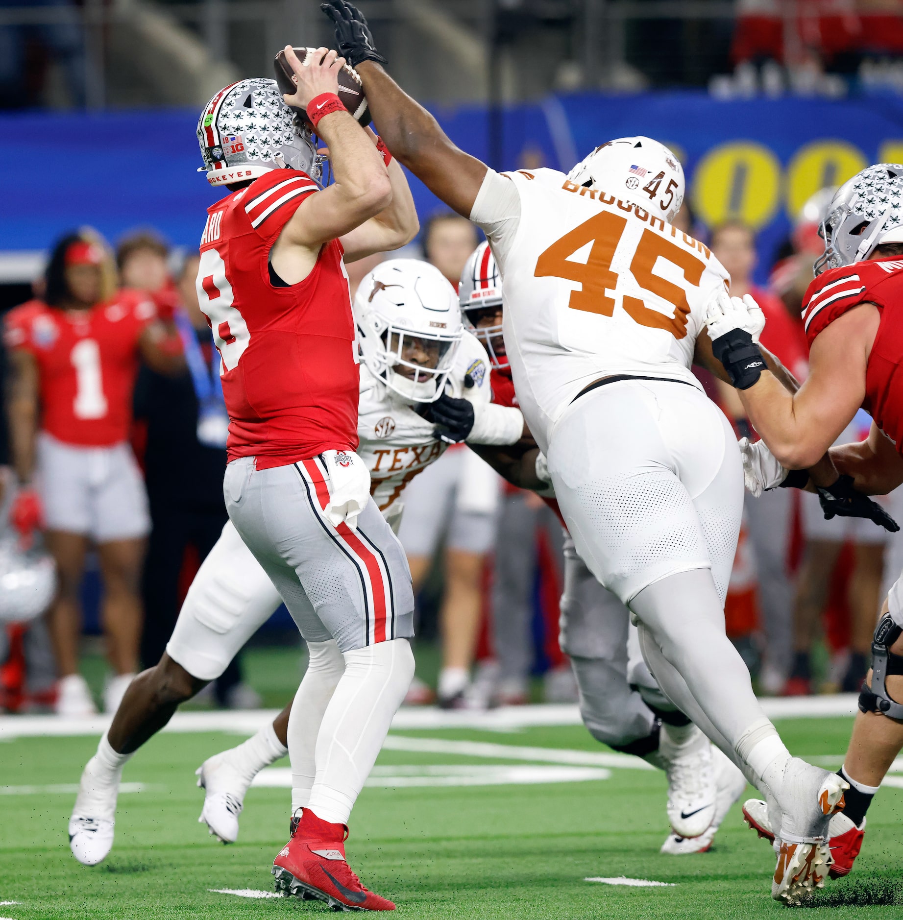 Texas Longhorns defensive lineman Vernon Broughton (45) jammed the football back into Ohio...