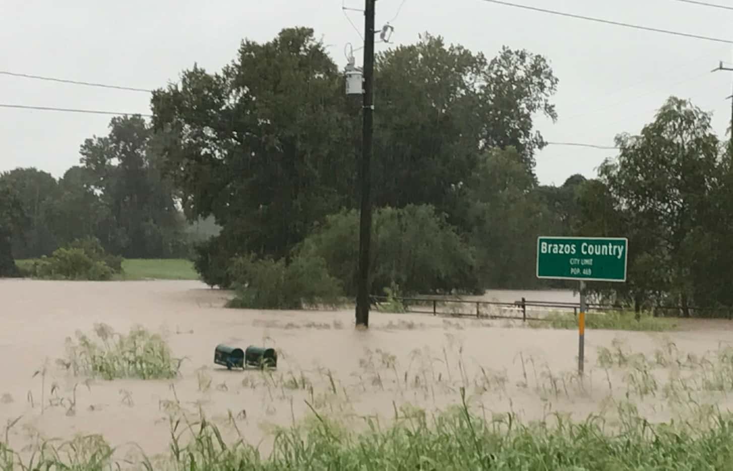 Floodwater from the Brazos River nearly reaches a pair of mailboxes in Brazos Country,...