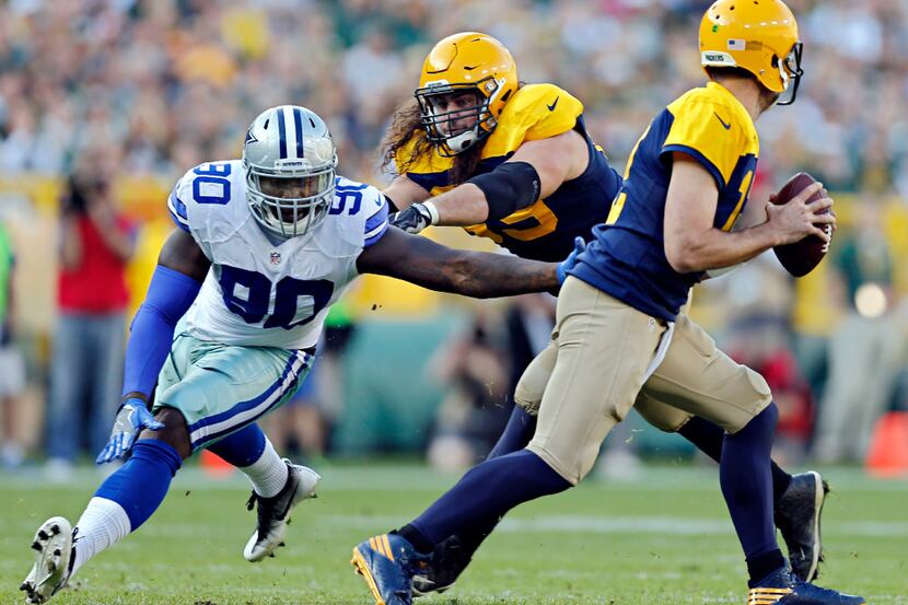 Dallas Cowboys defensive end Demarcus Lawrence (90) pressures Green Bay Packers quarterback...