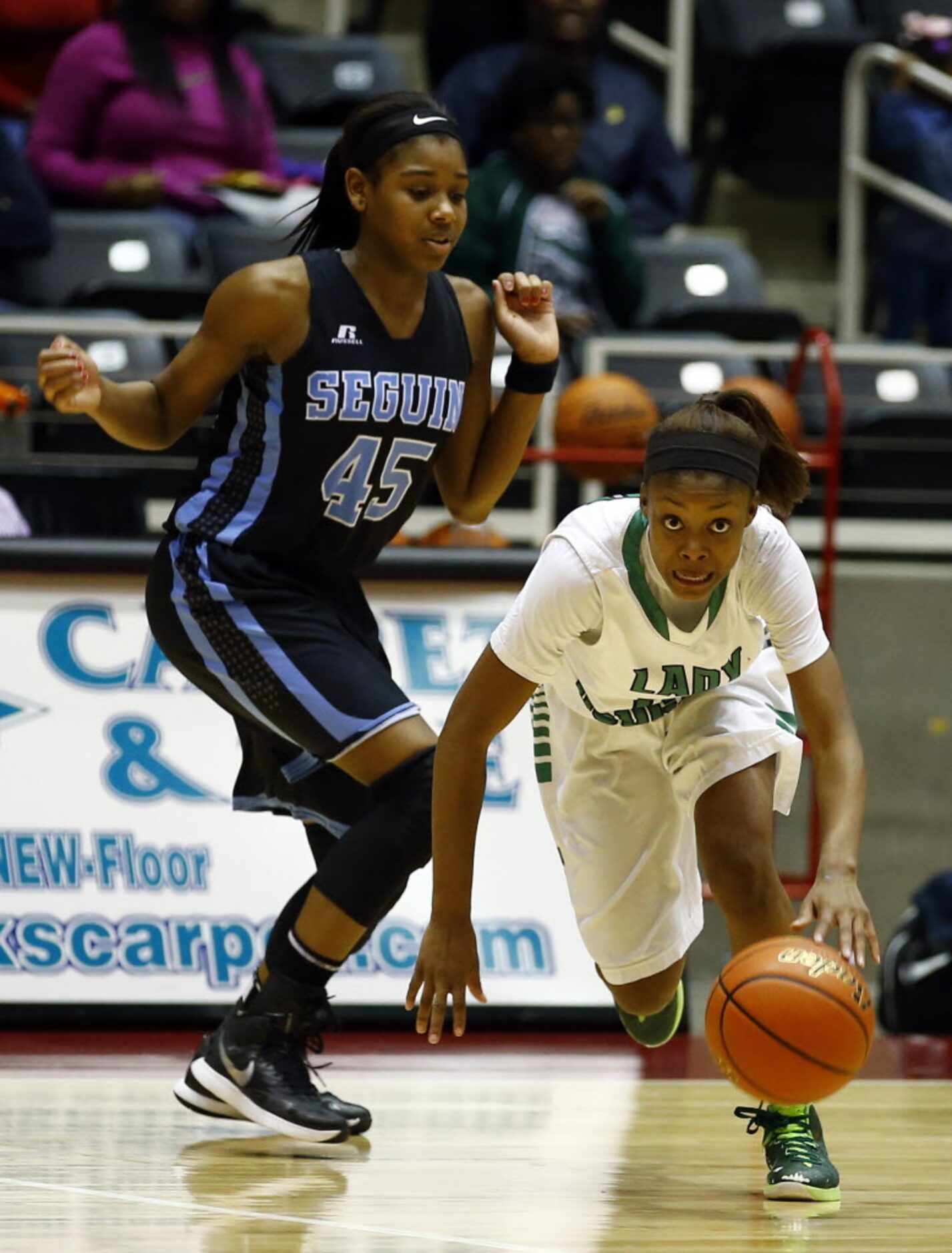 Bryan Adams' Alexxus Gilbert (12) drives past Arlington Seguin's Alarie Mayze (45) during...