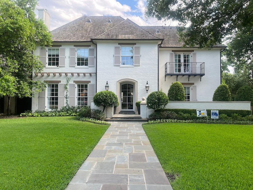 The white palette, a new front door, and a more modern balcony all come together for a...