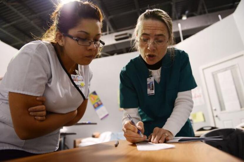 Catherine Henon  (right), registered nurse and CNA instructor at El Centro College, goes...