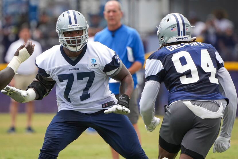 Dallas Cowboys tackle Tyron Smith (77) works against defensive end Randy Gregory (94) during...