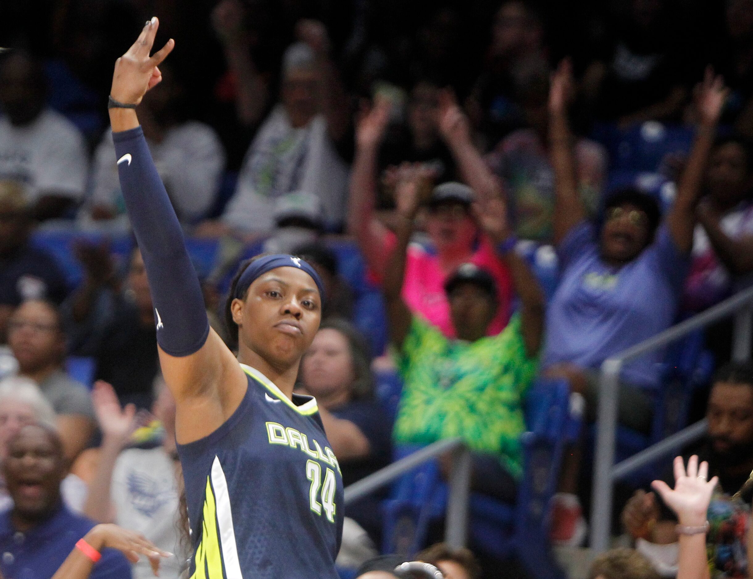 Dallas Wings guard Arike Ogunbowale (24) reacts by raising 3 fingers as fans celebrate after...