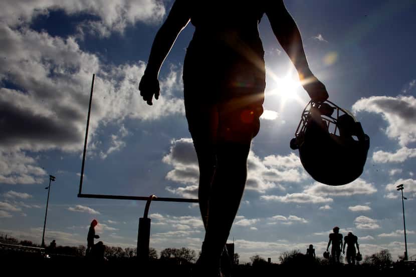 A Brock High School football player takes to the practice field under the supervision of...