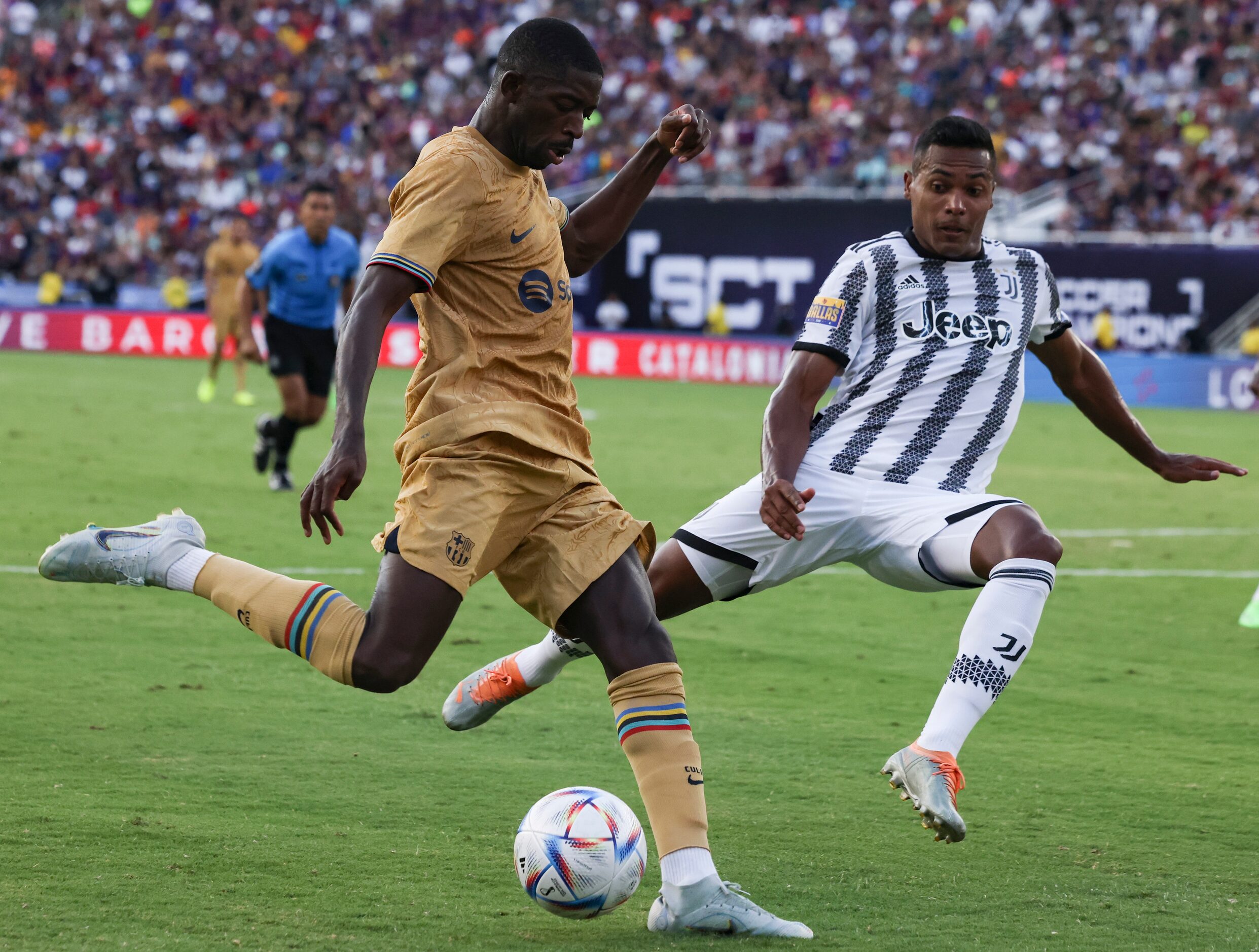 Barcelona forward Ousmane Dembélé (7) lunges to kick the ball as Juventus defender Alex...