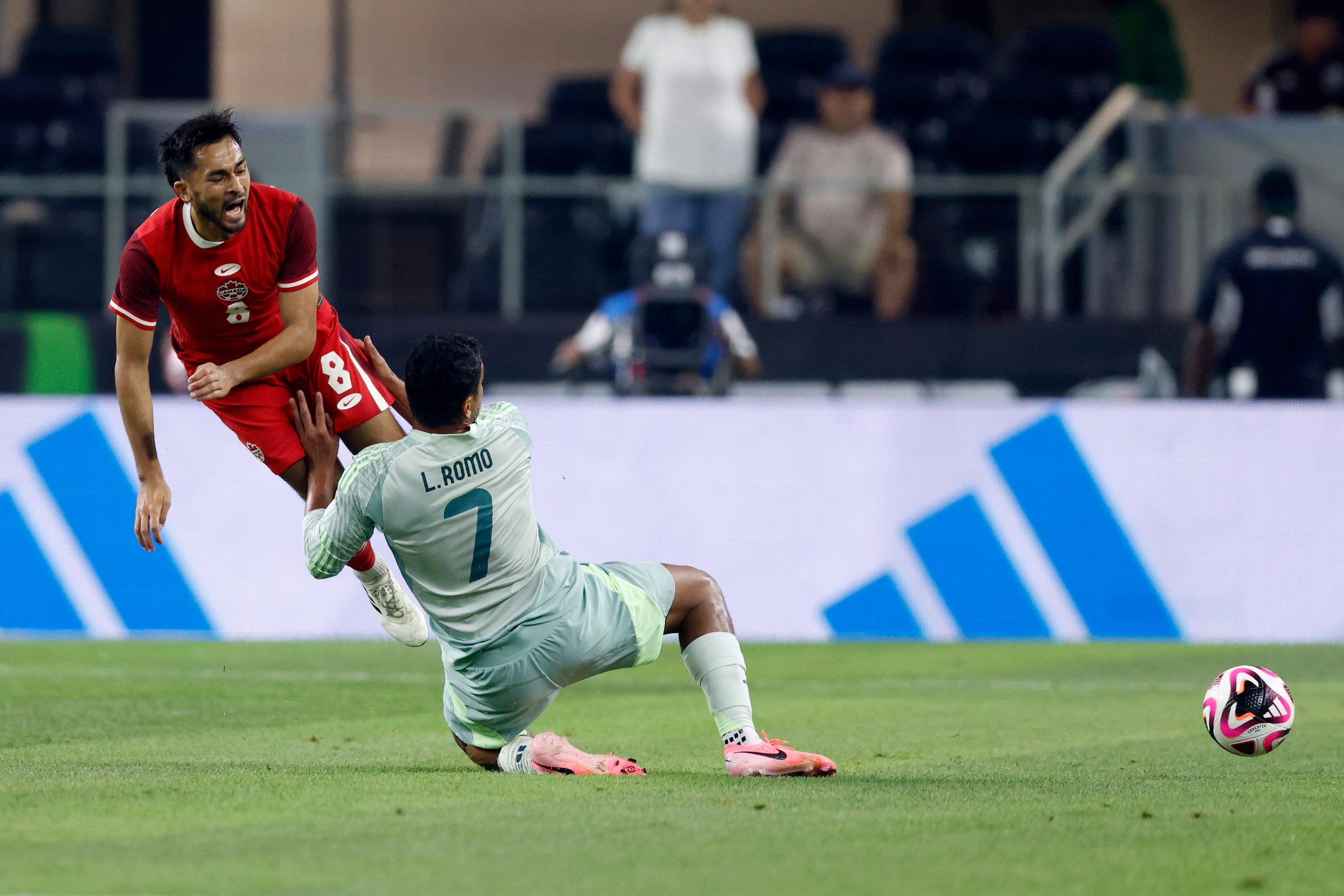 Canada midfielder Mathieu Choiniere (8) reacts after a tackle by Mexico midfielder Luis Romo...