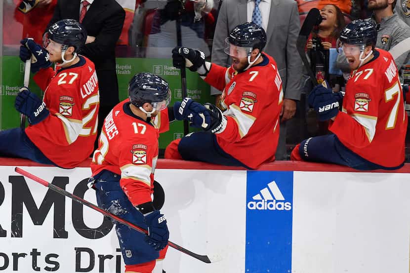 Florida Panthers center Evan Rodrigues (17) is congratulated by teammates after scoring...