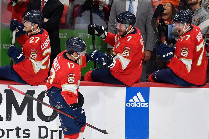 Florida Panthers center Evan Rodrigues (17) is congratulated by teammates after scoring...