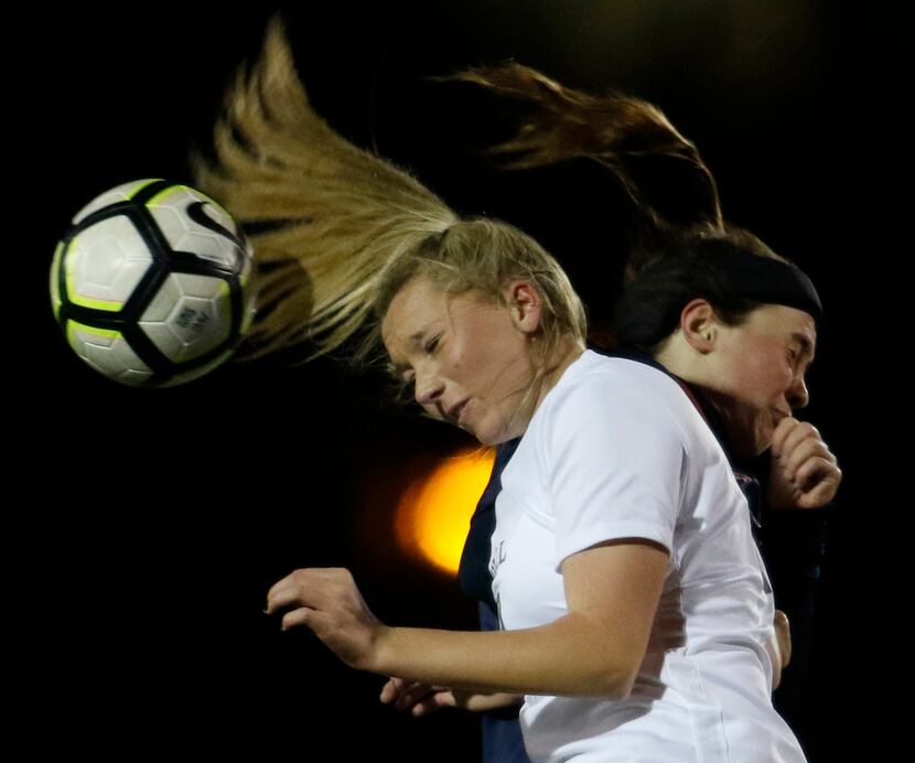Southlake Carroll defender Lauryn Mazick (23) foreground, winces after colliding with Allen...