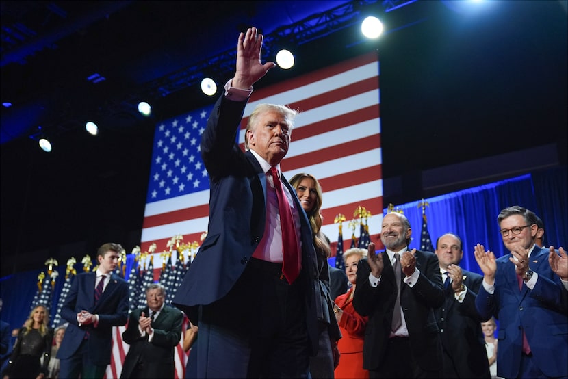 President-elect Donald Trump waves as he walks with Melania Trump at an election night watch...