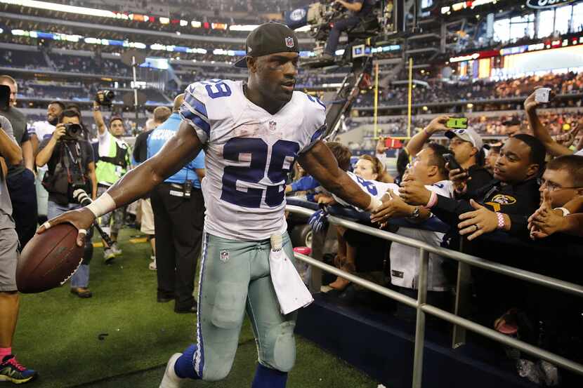 Dallas Cowboys running back DeMarco Murray (29) shakes hands with fans as he keeps the game...