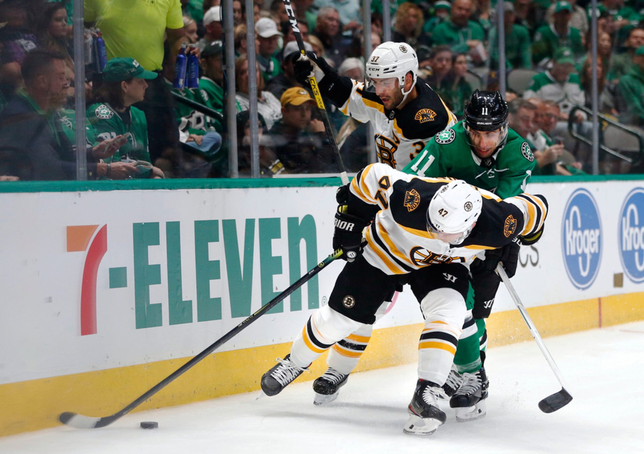 Dallas Stars center Andrew Cogliano (11), Boston Bruins center Patrice Bergeron (37) and...