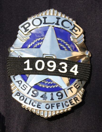 A badge features a black ribbon and Rogelio Santander's badge number Thursday.