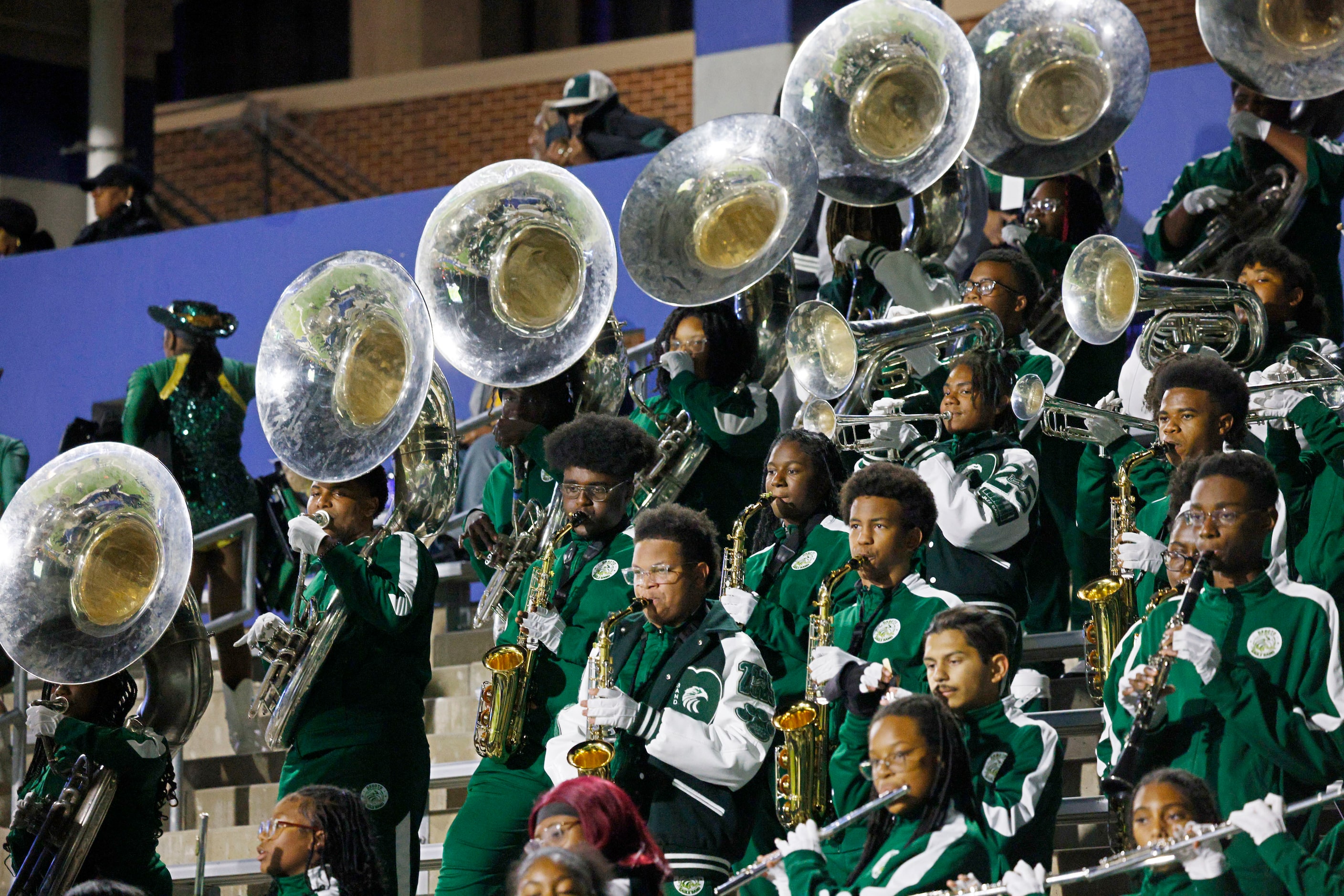 DeSoto’s marching band members perform in the first half of a high school football game...