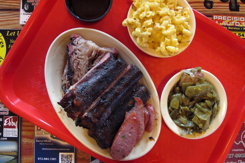 Three-meat platter of ribs, brisket and jalapeno sausage at Hutchins BBQ in McKinney, Texas,...