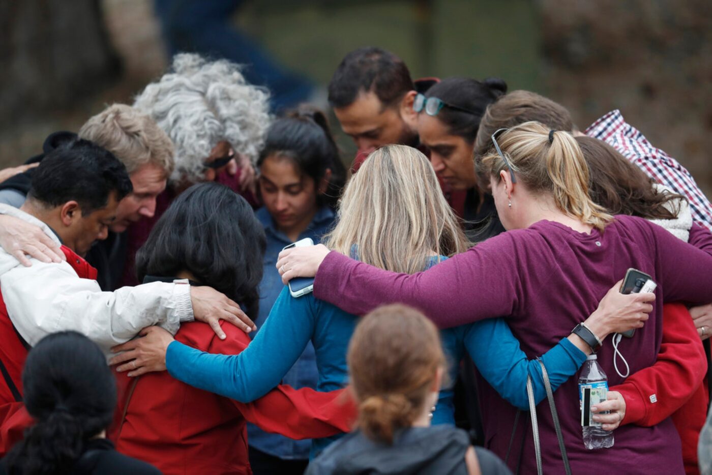 Parents gathered in a circle to pray at a recreation center where students were reunited...