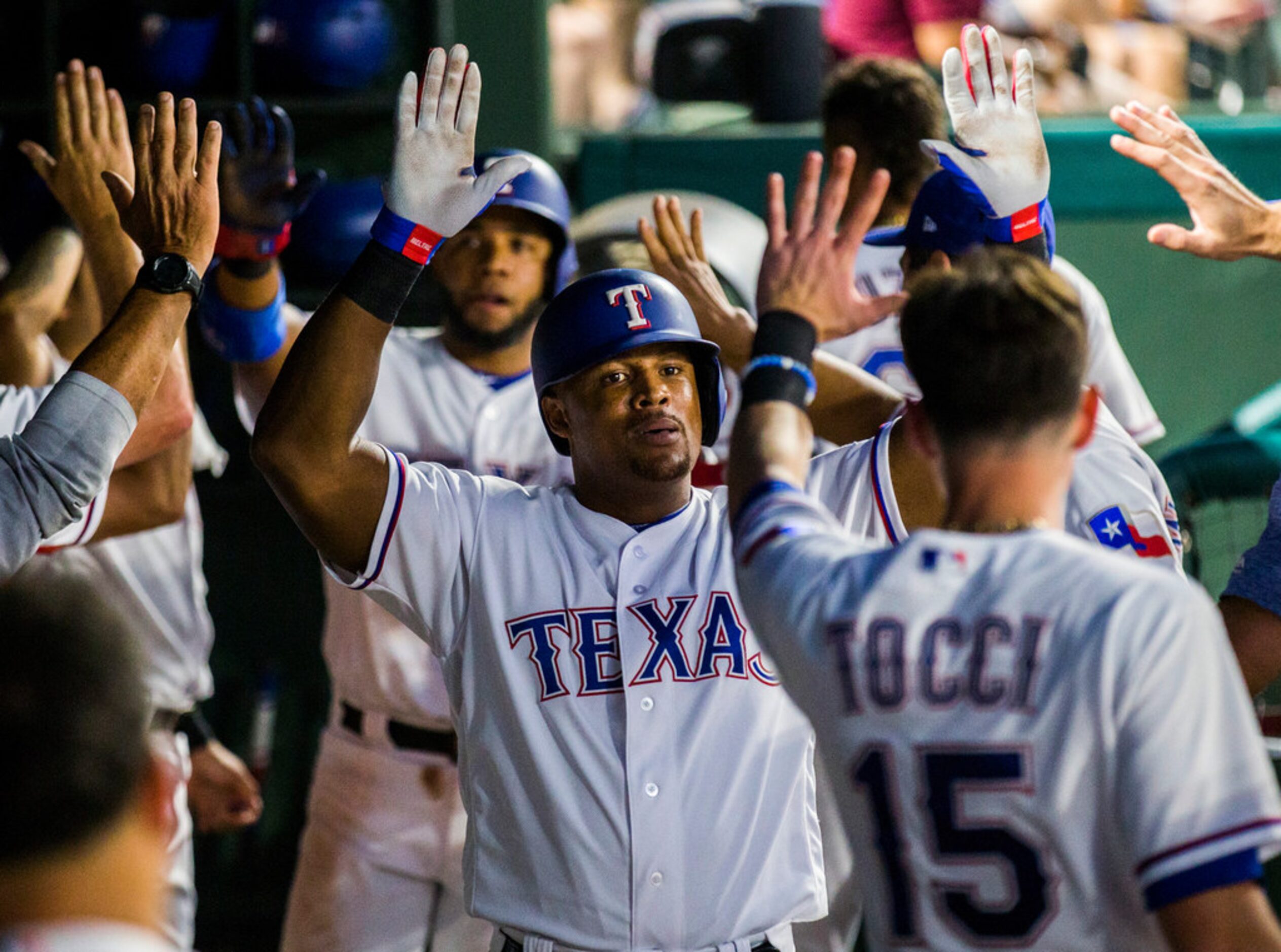 Texas Rangers designated hitter Adrian Beltre (29) and shortstop Elvis Andrus (1) get high...