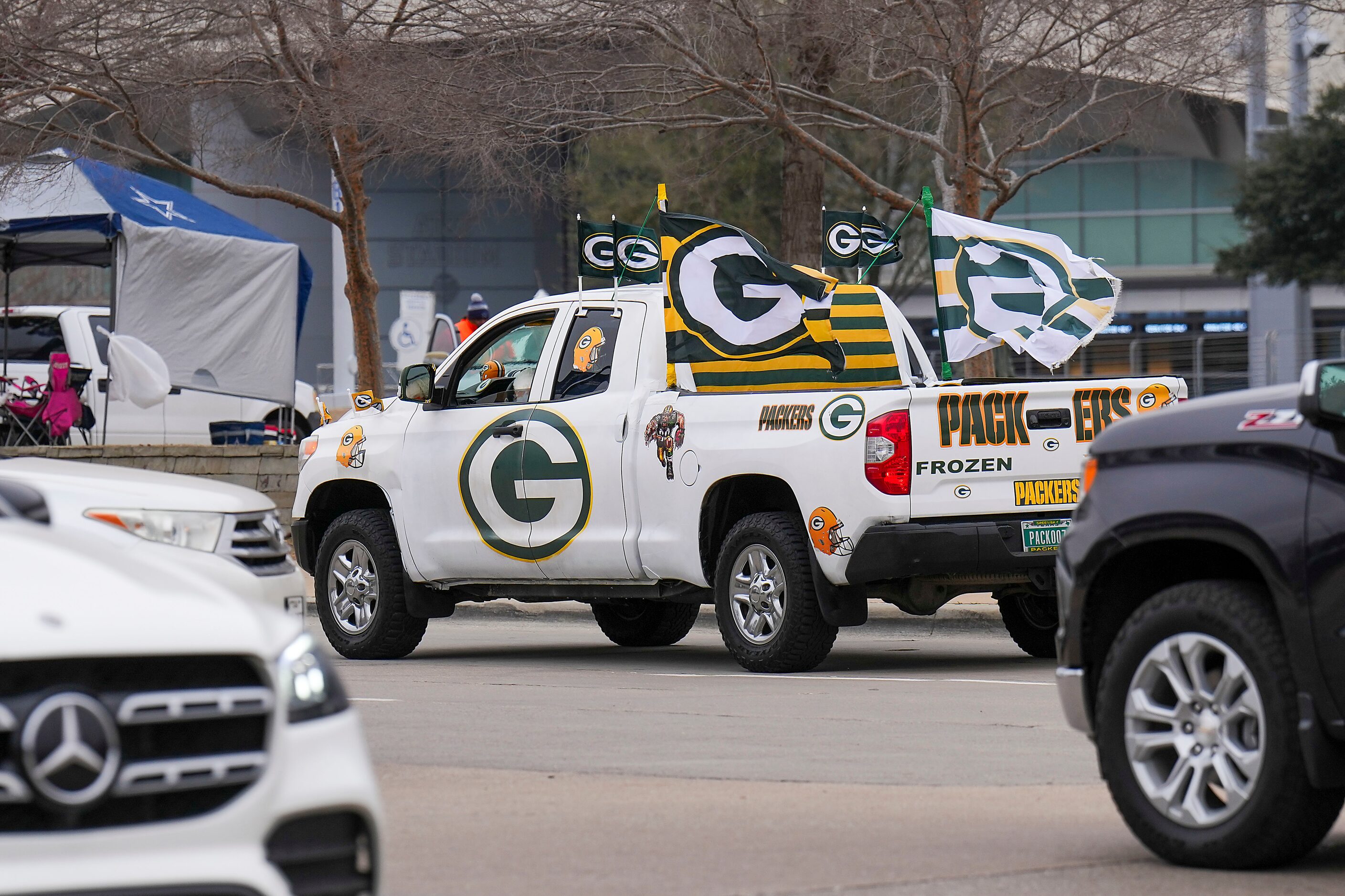 A Green Bay Packers fan drives past the stadium before an NFL wild-card playoff football...