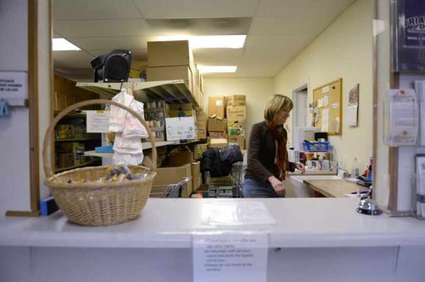 
Volunteer Kay Tyler helps distribute food at the Cedar Hill Food Pantry on Jan. 3, 2014....