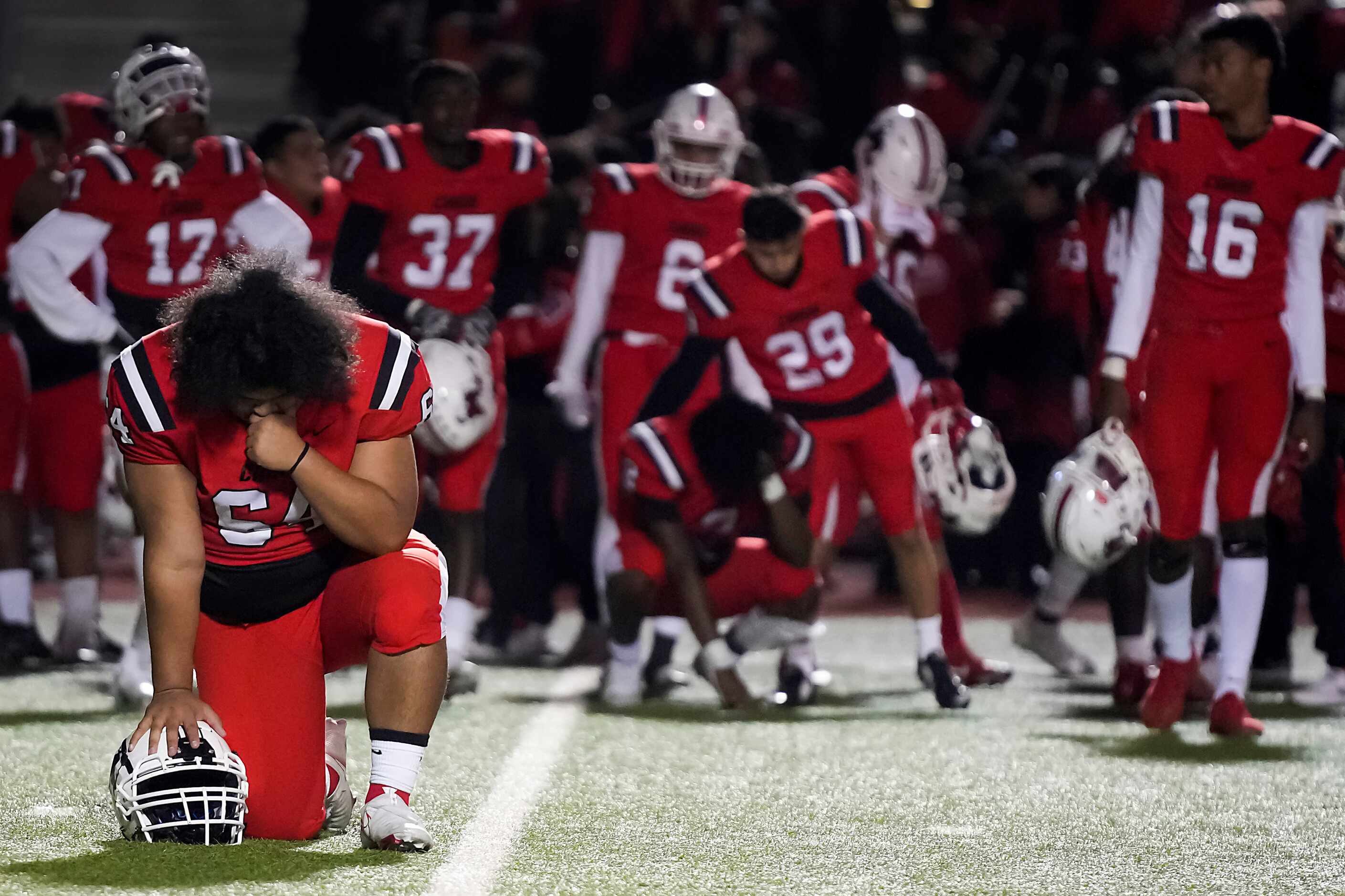 Irving MacArthur’s kneels on the field after a loss to Richardson JJ Pearce in a District...