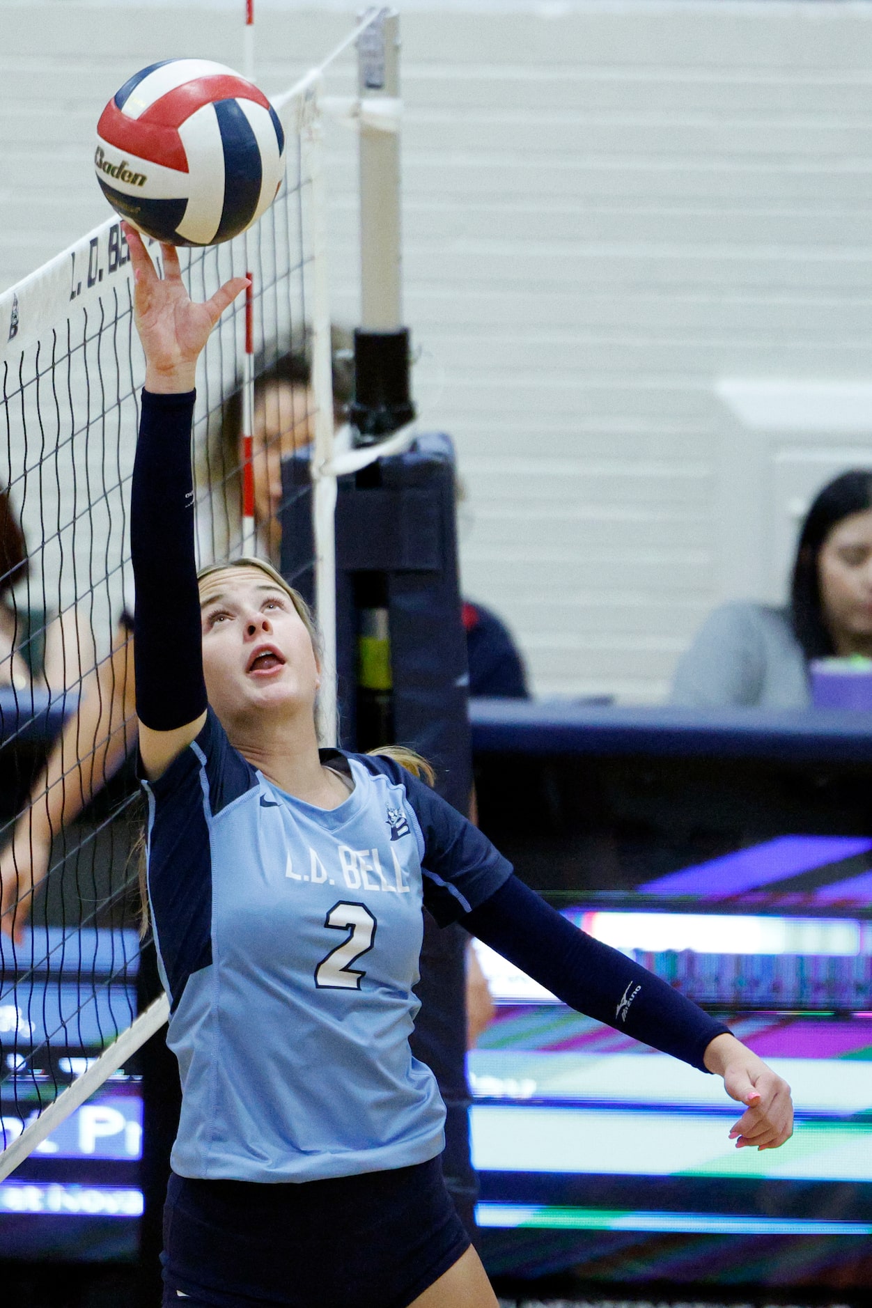 L.D. Bell's Presle Tarver (2) tips the ball to a teammate during a volleyball match against...