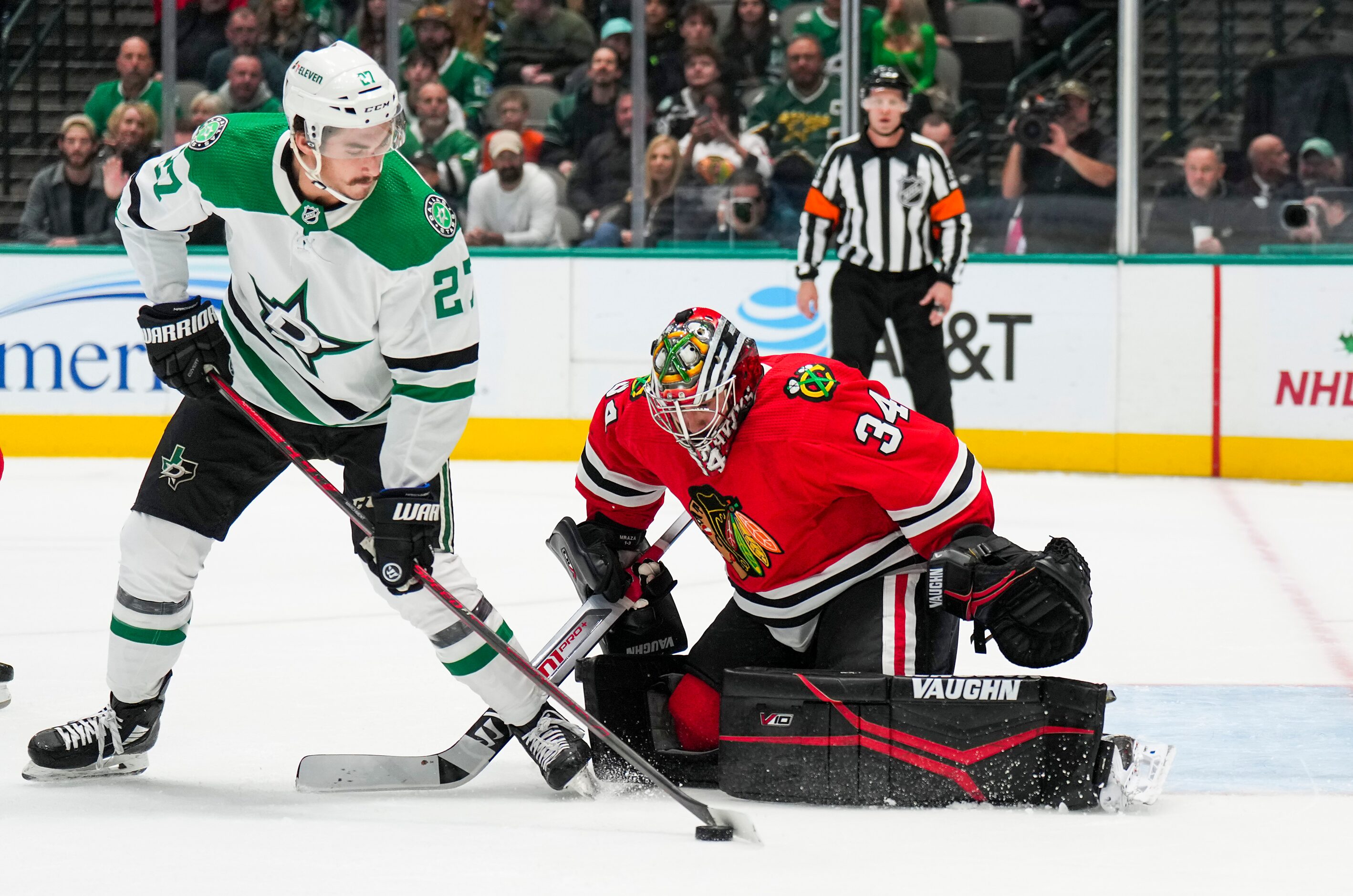 Dallas Stars left wing Mason Marchment (27) is turned away by Chicago Blackhawks goaltender...