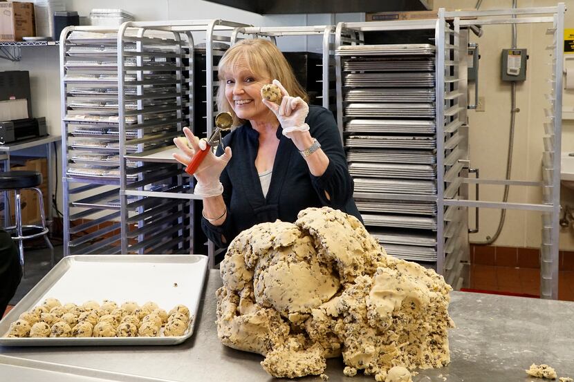 The Festive Kitchen owner Sandy Korem scoops the 8-millionth scoop of cookie dough at her...