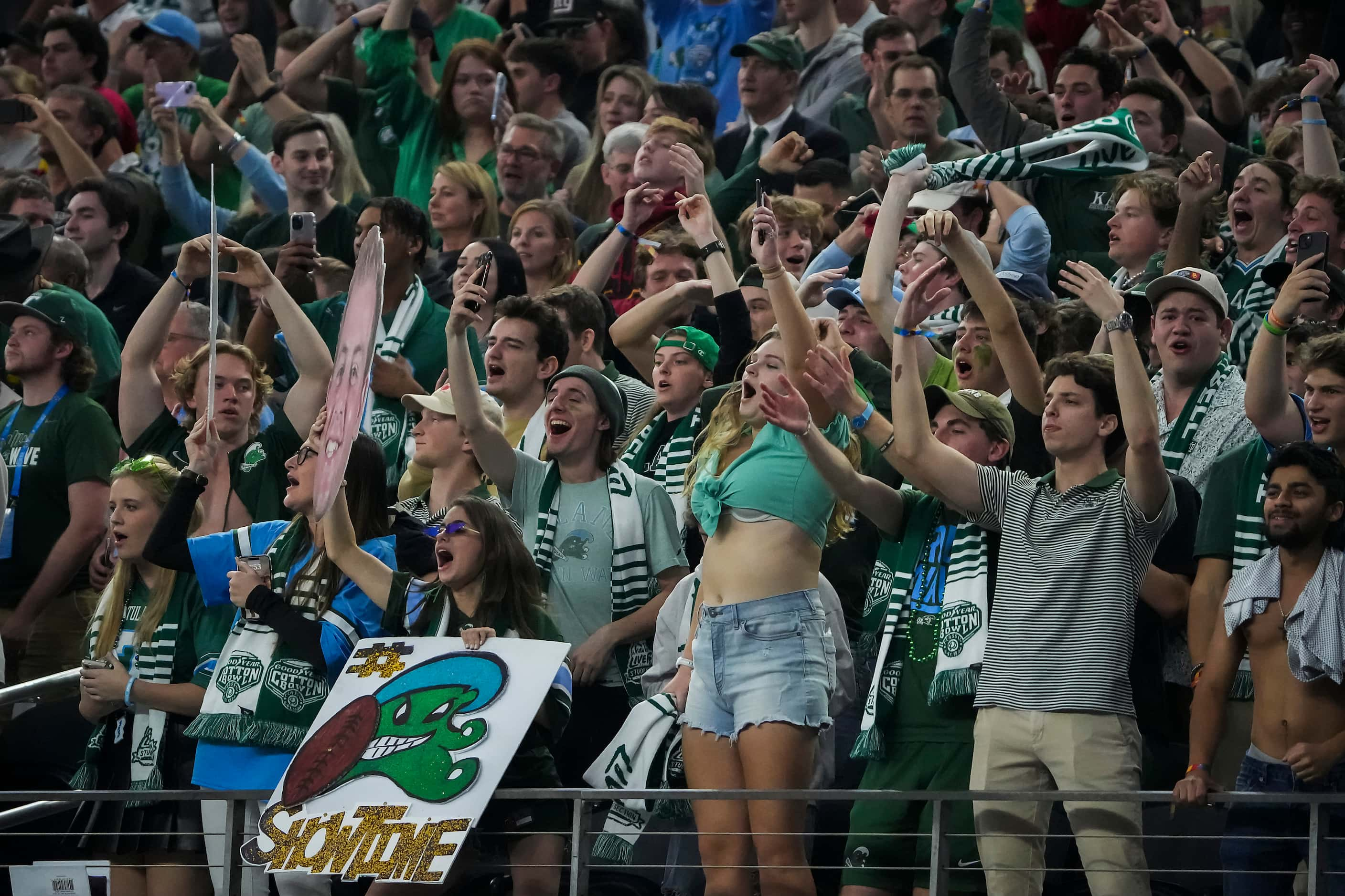 Tulane fans celebrate after a replay review gave tight end Alex Bauman a 6-yard touchdown...