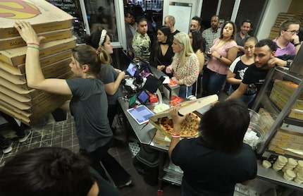 Employees prepare a steady flow of pizza during a 2 a.m. rush at Zalat Pizza in Dallas. We...