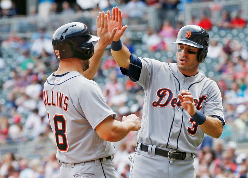Detroit Tigers' Tyler Collins, left, and Ian Kinsler celebrate after they scored on a...