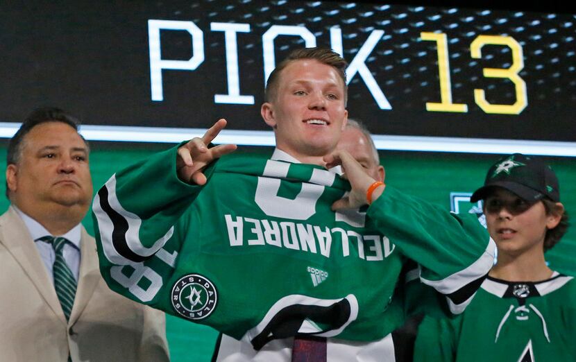 Dallas Stars first round draft pick Ty Dellandrea tries on a Stars' sweater after being...