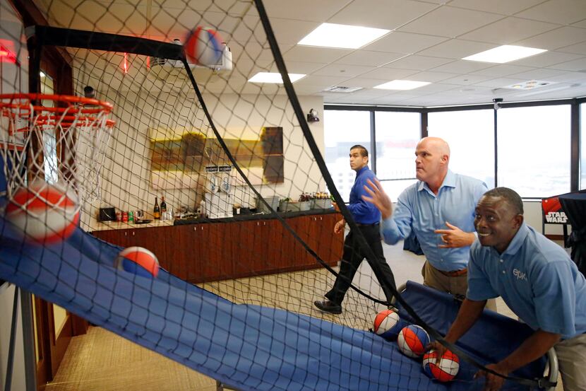 CEO Phil Appenzeller plays a game of basketball with Marcus Morgan during an employee event...