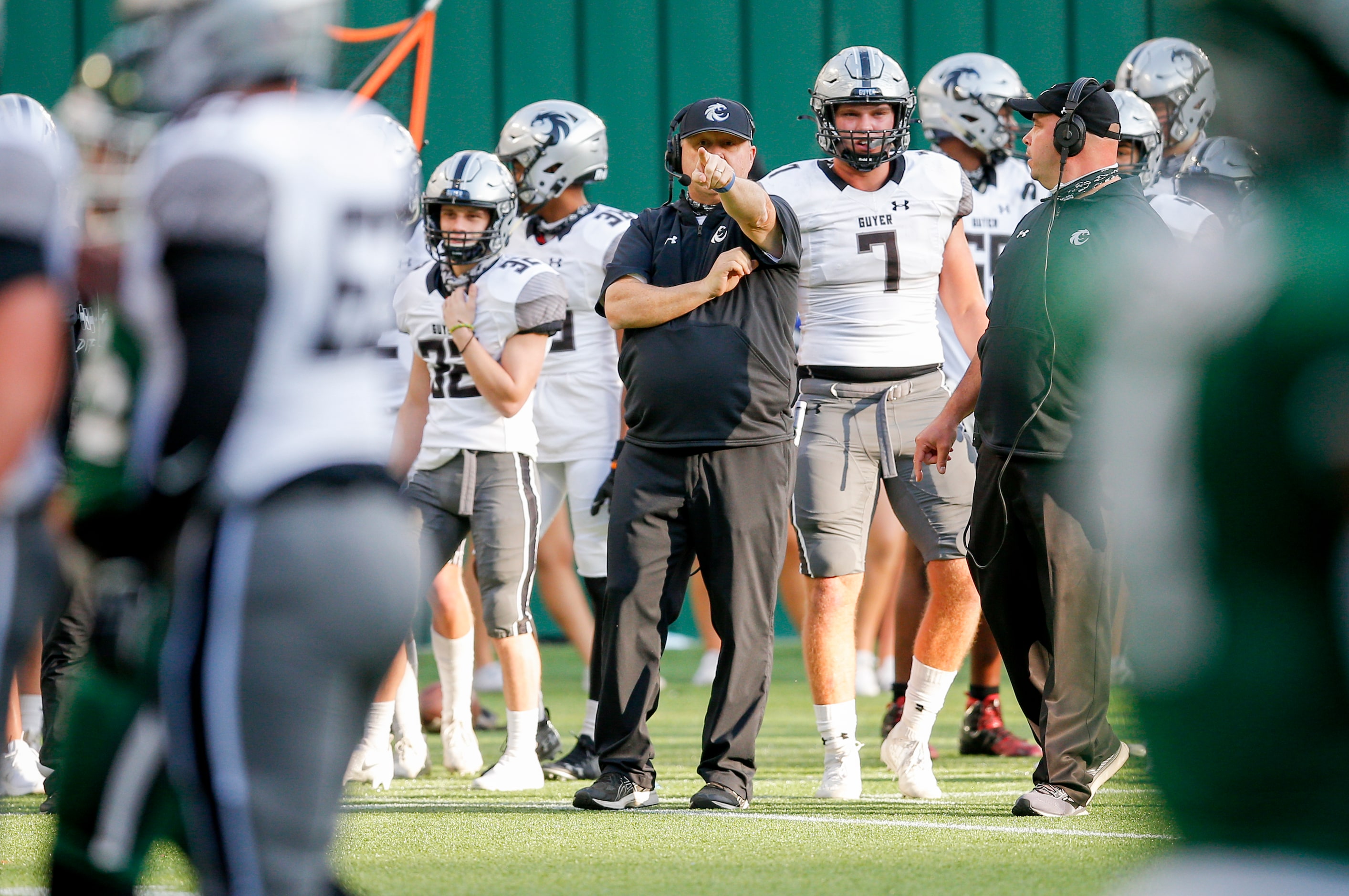 Denton Guyer head coach Rodney Webb, center, looks on during the first half of a high school...