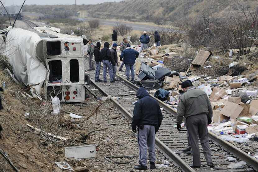 Authorities investigate the scene of a prison bus crash, Wednesday in Penwell, Texas, near...