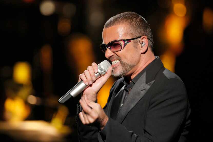 British singer George Michael sings in concert to raise money for AIDS charity Sidaction, in...
