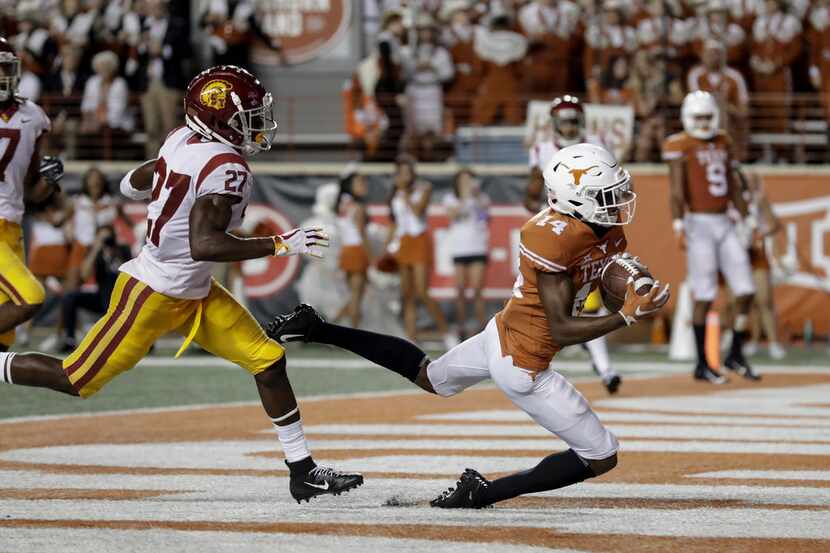 FILE - Texas receiver Joshua Moore hauls in a touchdown pass against USC during the 2018...