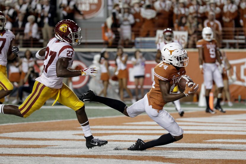 AUSTIN, TX - SEPTEMBER 15:  Joshua Moore #14 of the Texas Longhorns catches a pass for a...