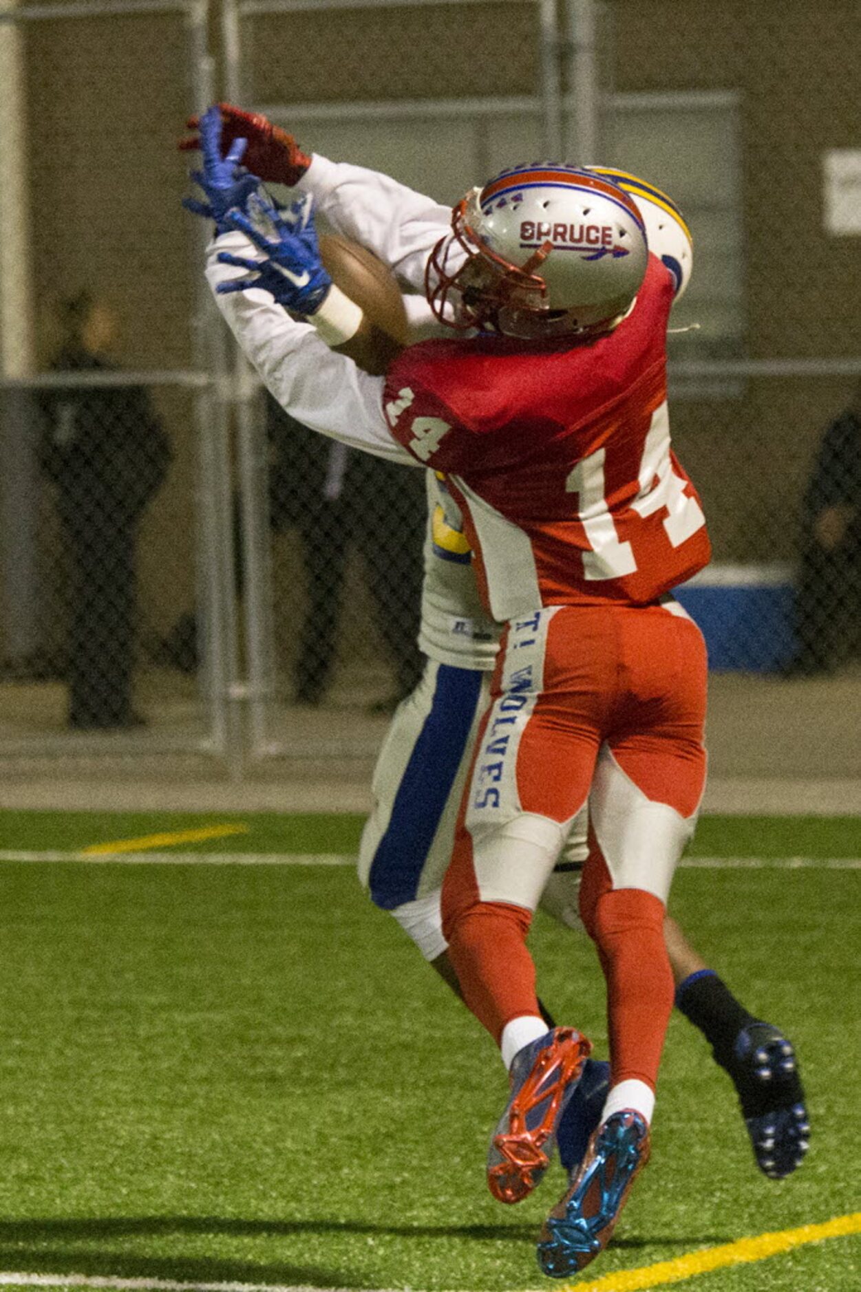 Spruce's Geremy Ross (14) attempts to catch a pass in the endzone during W. W. Samuell's...