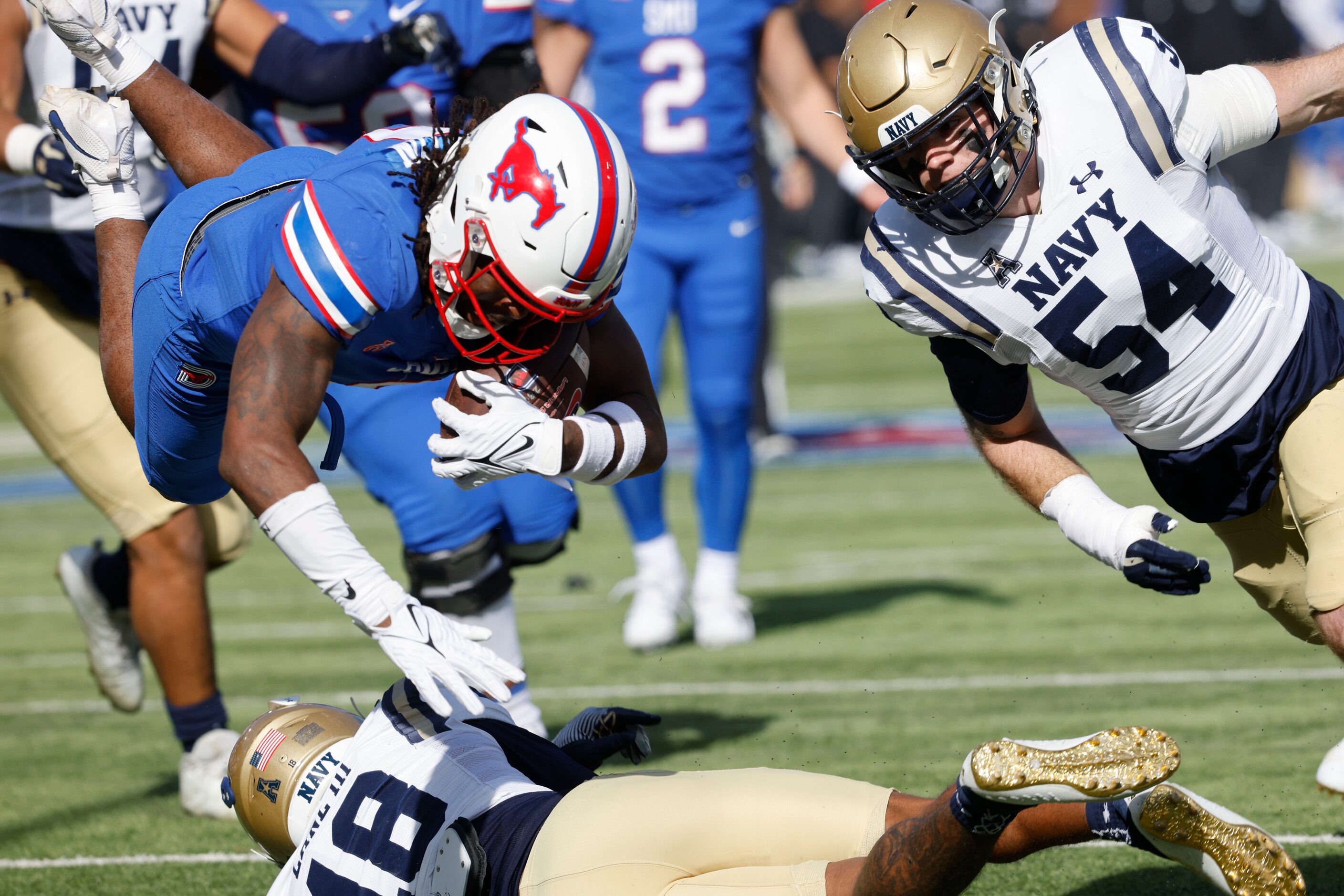 SMU running back Camar Wheaton (0) tries to score a touchdown over Navy safety Rayuan Lane...