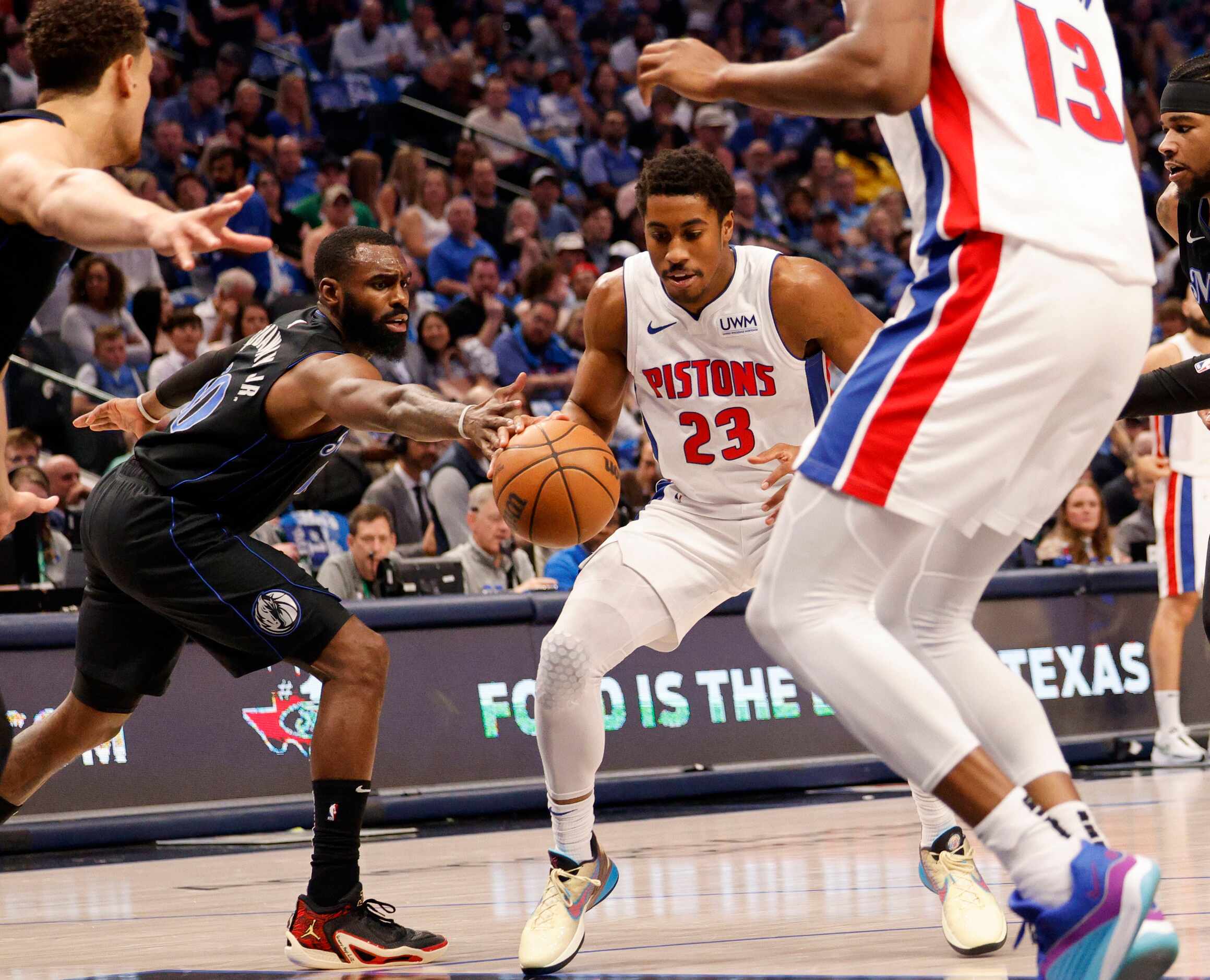 Detroit Pistons guard Jaden Ivey (23) tries to drive past Dallas Mavericks forward Tim...