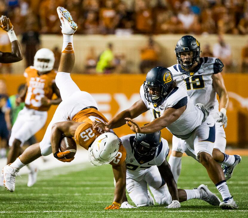 Texas running back Chris Warren III (25) is knocked off his feet by California safety...