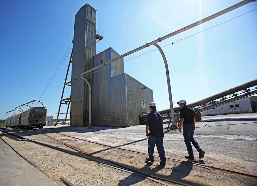 
Chuck Boyer (left) and acting mine superintendent Alan Stewart make their way to the lift...