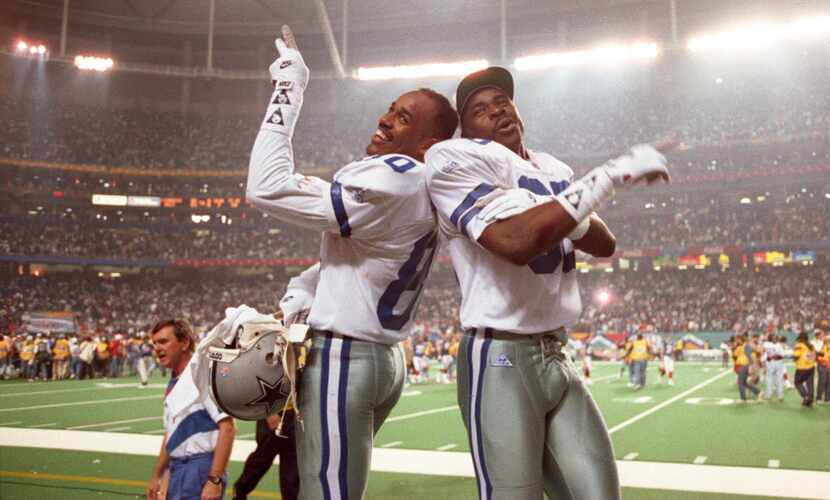 Dallas Cowboys Alvin  Harper (L) and Michael Irvin climbed on the Buffalo Bill's bench after...