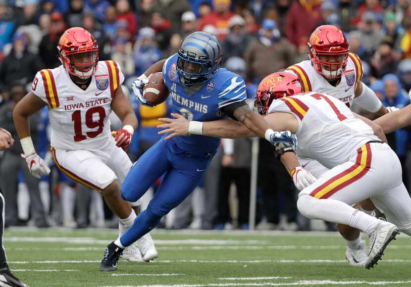 Memphis wide receiver Anthony Miller (3) fights through a tackle by Iowa State linebacker...