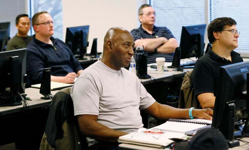 
Andrew Brown (center), an army veteran, and other veterans participate in a computer...