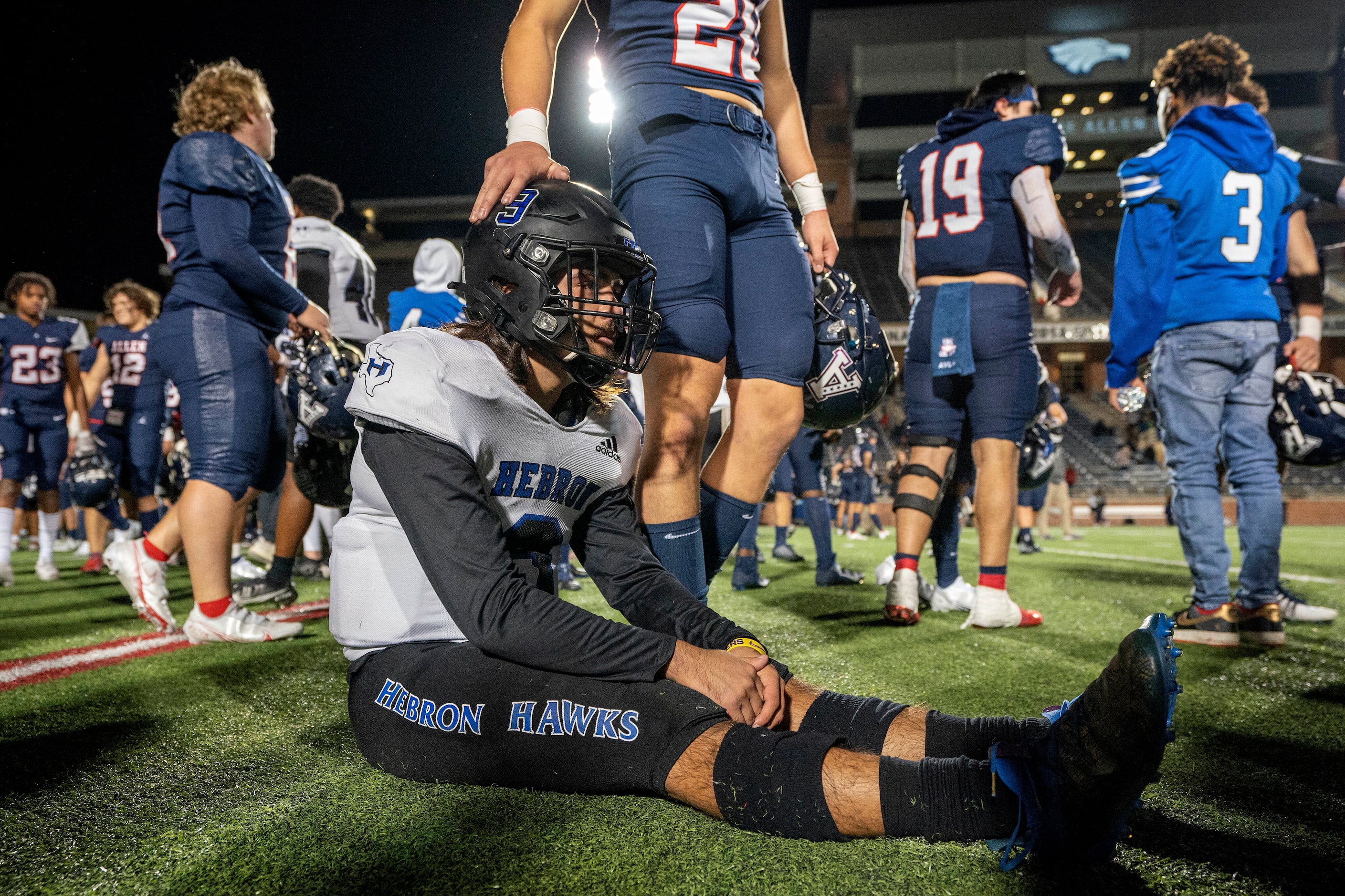 Hebron quarterback Jacob Buniff (9) is consoled by Allen senior wide receiver Tristan...