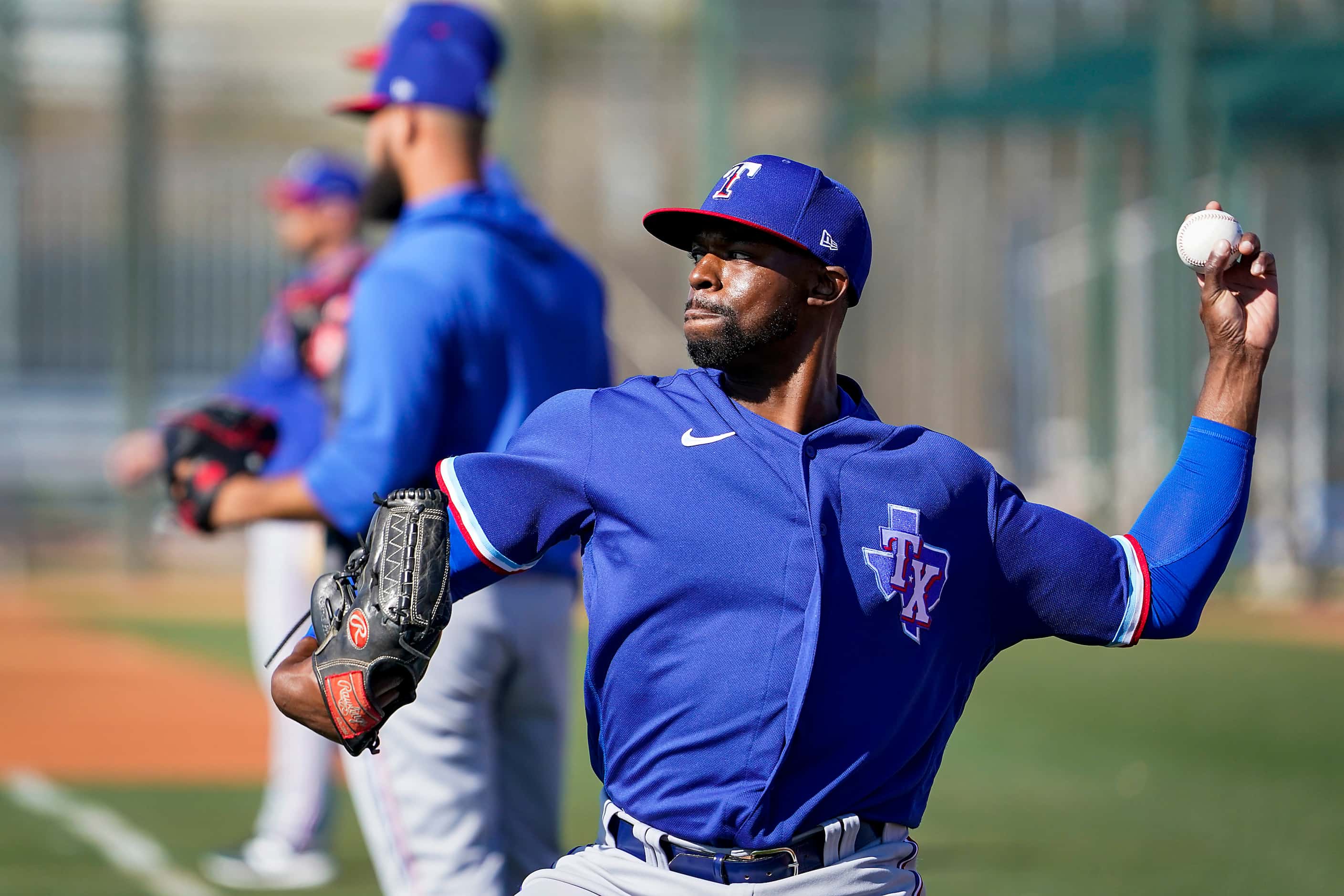Texas Rangers pitcher James Jones plays catch during a spring training workout at the team's...