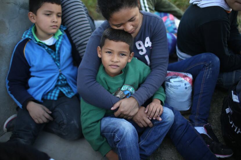  A Honduran mother holds her son after she turned her family in to Border Patrol agents on...