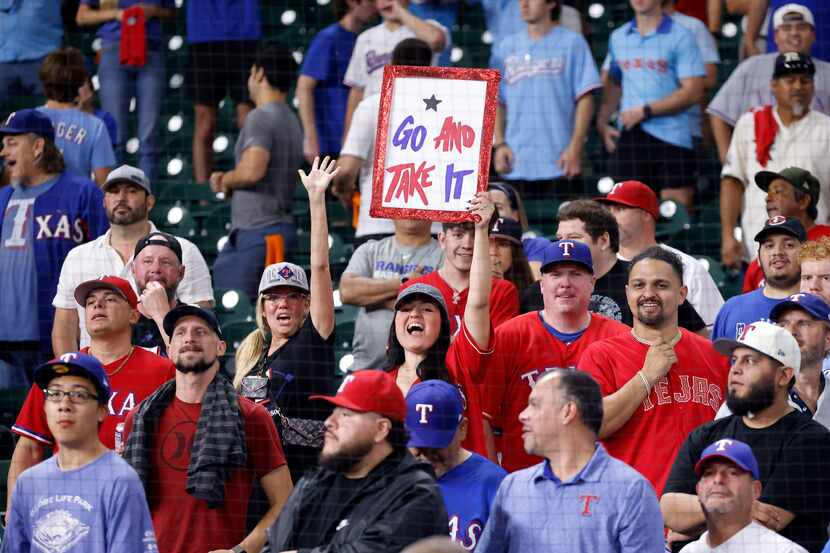 Texas Rangers fans congratulate the team after defeating the Houston Astros in Game 7 of the...